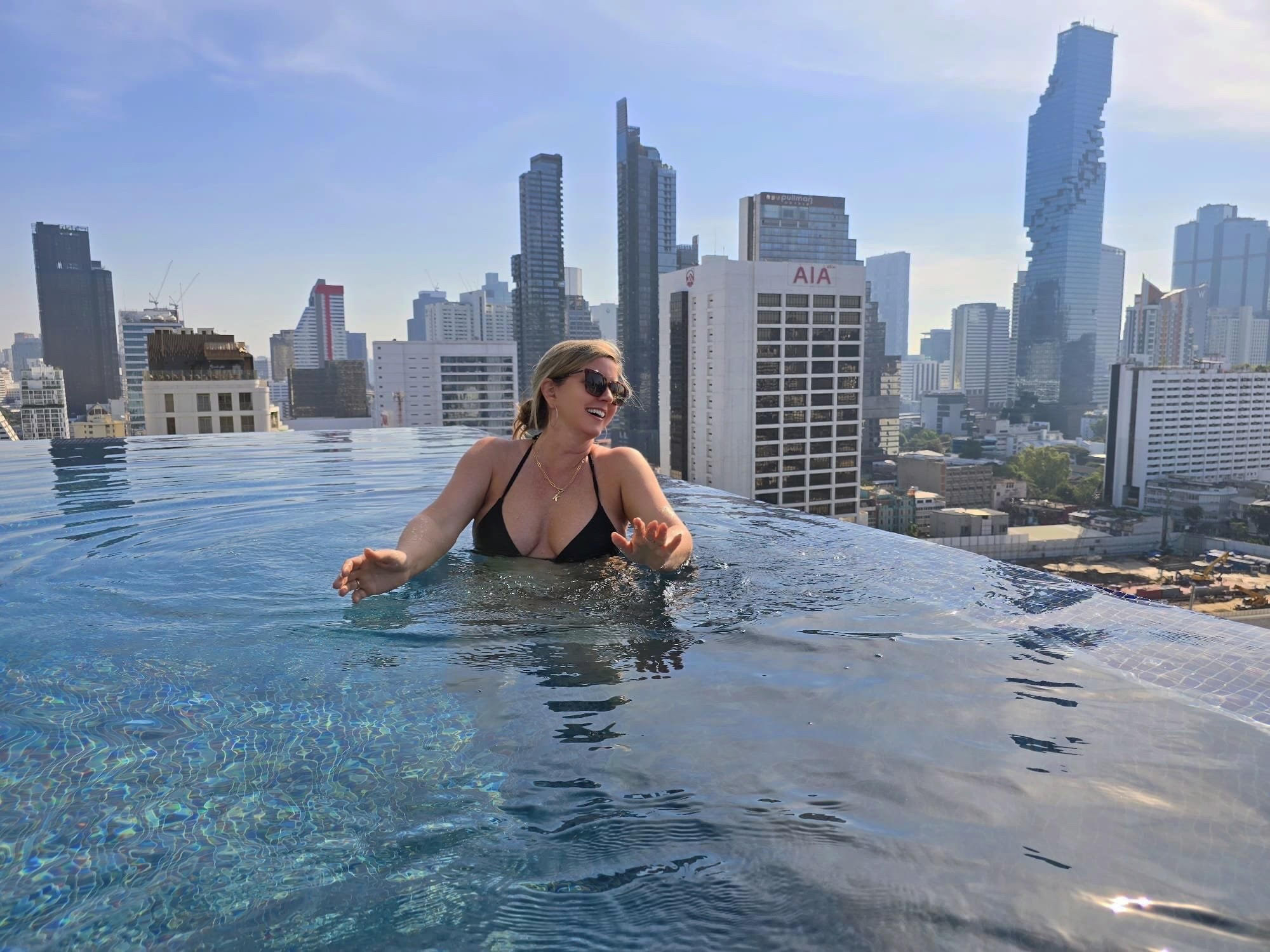 Rooftop infinity pool at the Bangkok Marriott Hotel The Surawongse, with the Bangkok skyline beyond