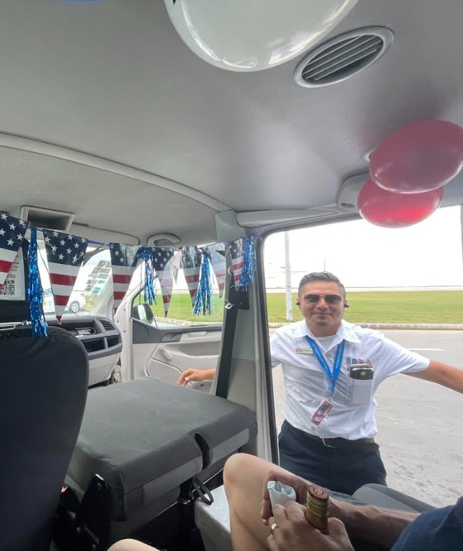USA Transfers driver with patriotic decor inside the van