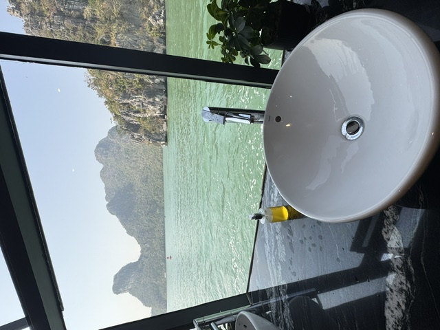 Window behind the bathroom sinks looking straight out over Ha Long Bay