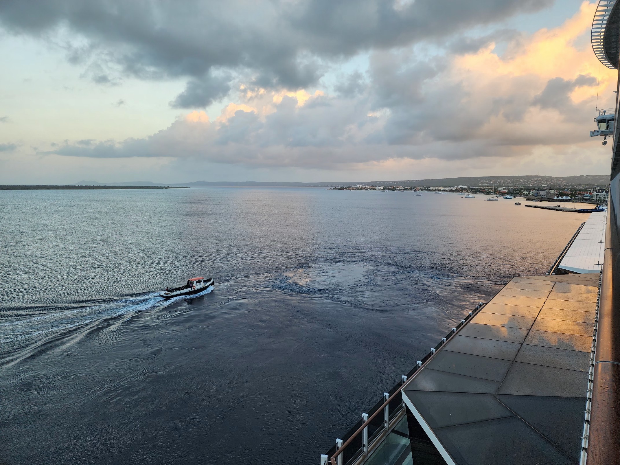 A pilot boat heads out to meet the Norwegian Viva at dawn, seen from our balcony