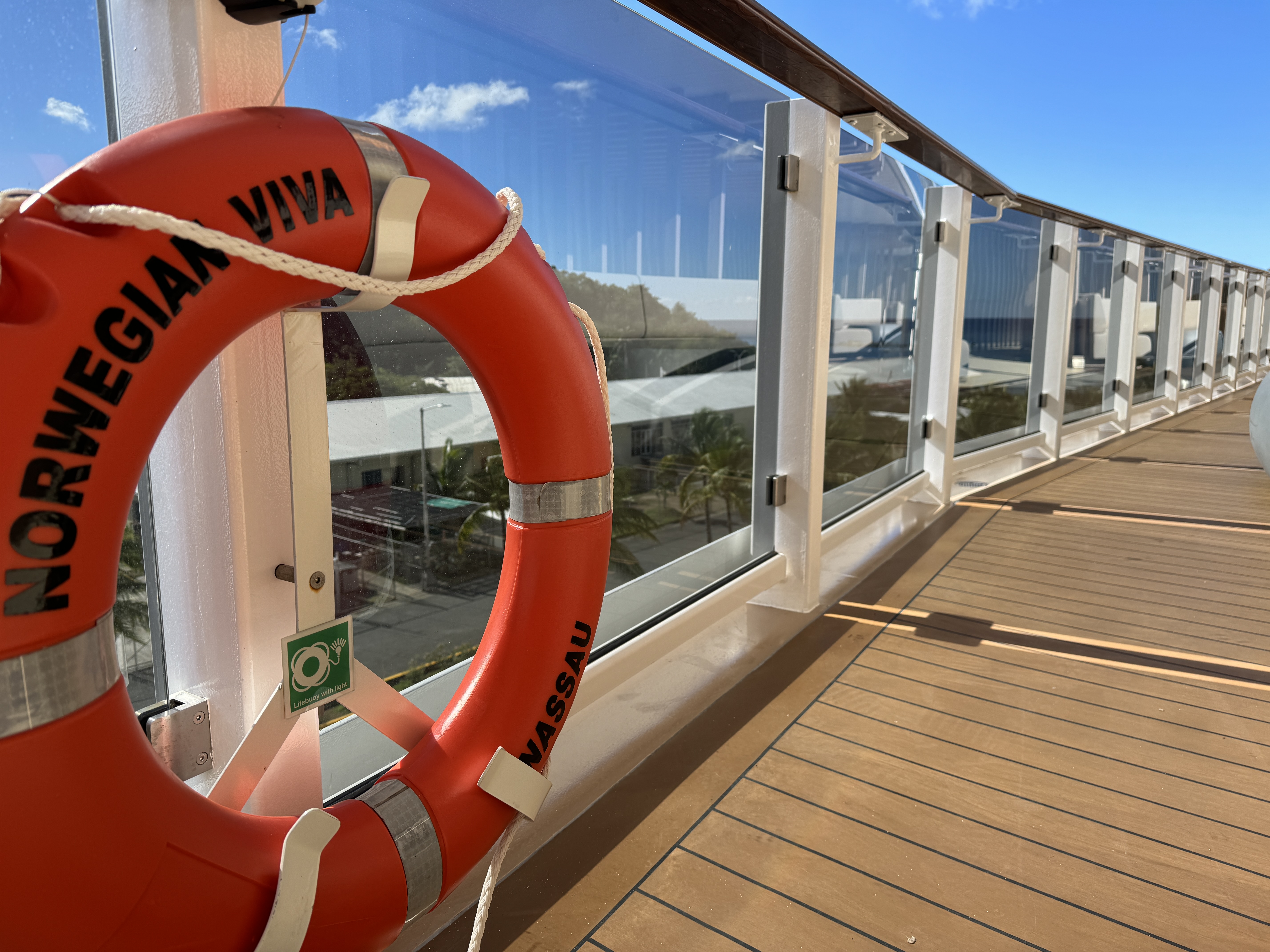 A Norwegian Viva life ring on the ship's teak promenade deck