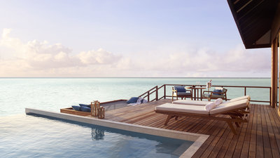 Overwater villa sundeck at Anantara Veli Maldives, with loungers above the lagoon in South Malé Atoll