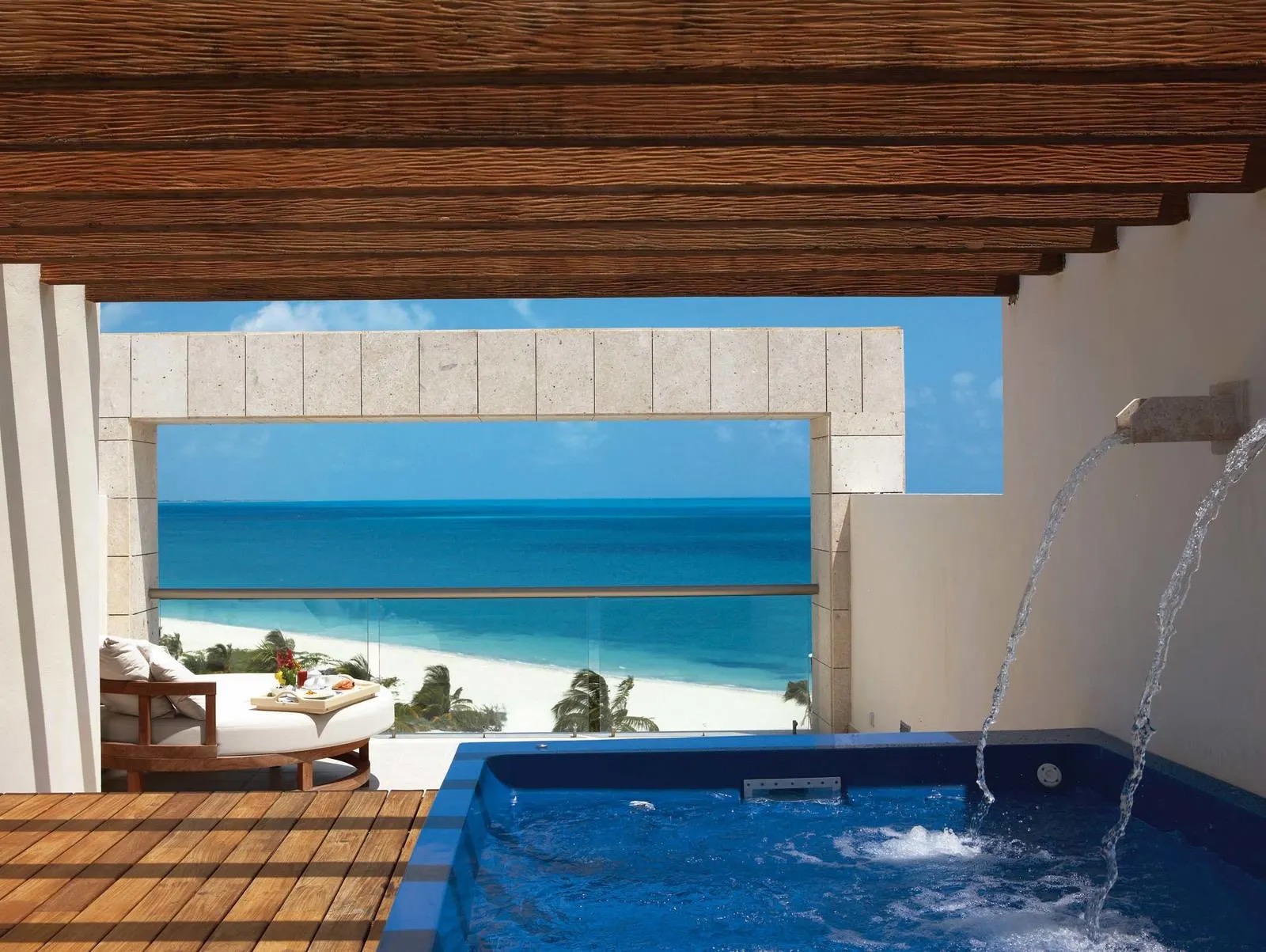 Private rooftop plunge pool at an Excellence Playa Mujeres Terrace Suite, with water spouts and the Caribbean beyond